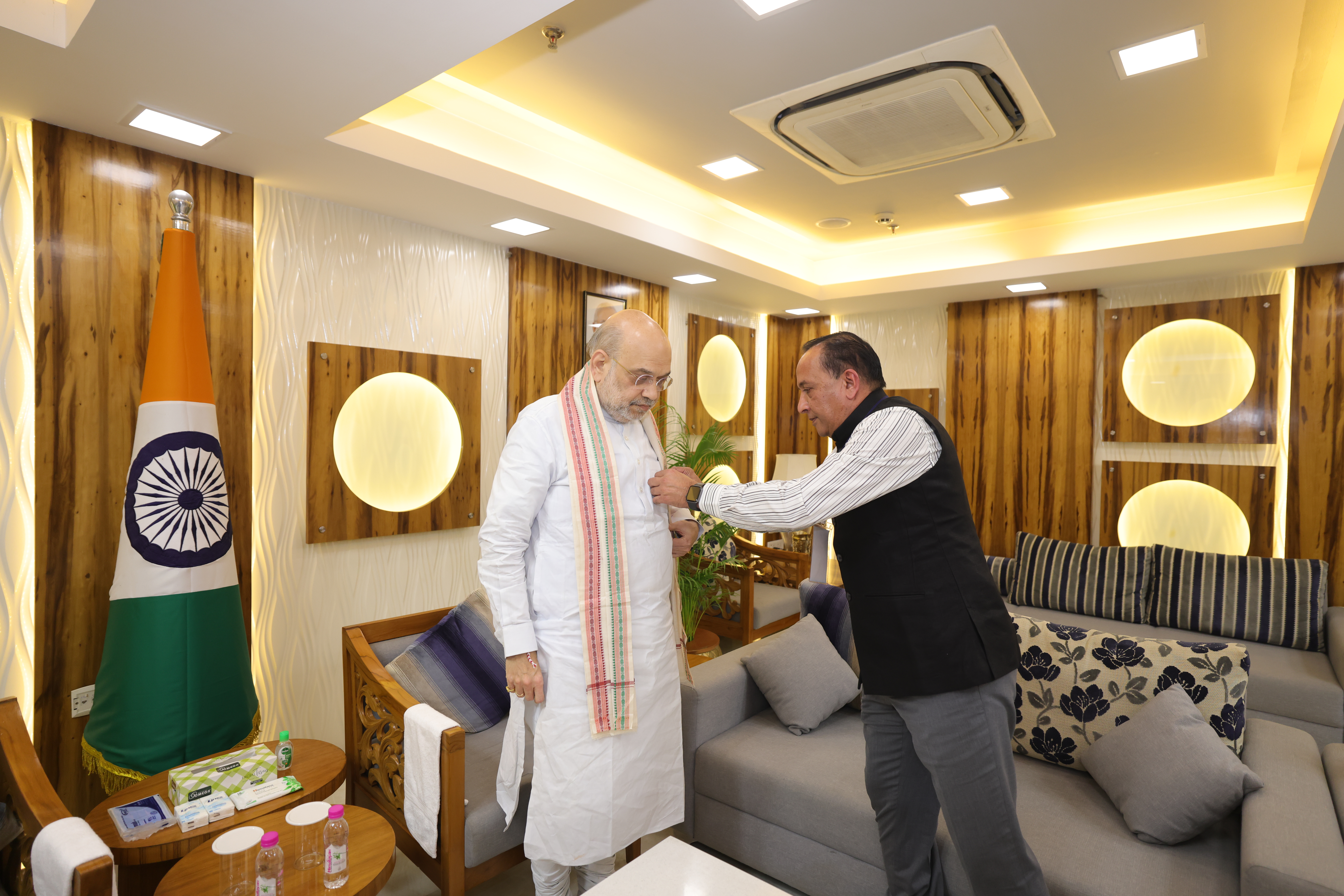 Union Home Minister and Minister of Cooperation Amit Shah by pinning the flag
